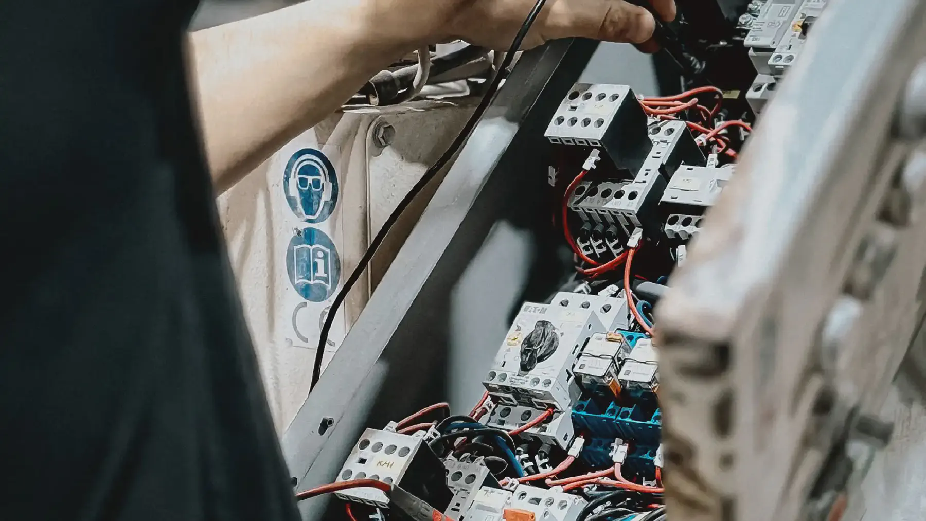 Contactors and terminal blocks inside an industrial control cabinet