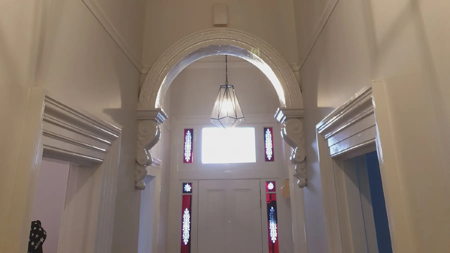 Pendant lighting in the entry hall of a large Kew home
