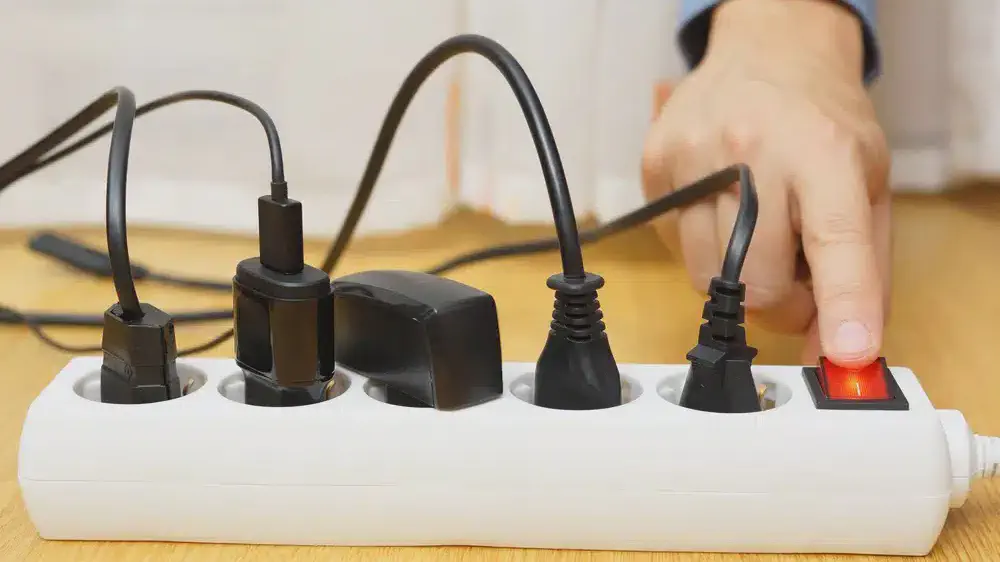 Surge protector fitted to a power outlet